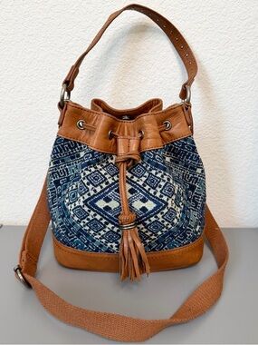 The Sak Boho Drawstring Bucket Bag in Navy Tapestry and Tan Leather